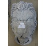 A concrete lion wall mask