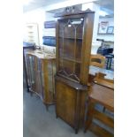 A mahogany freestanding corner cabinet