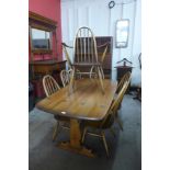 An Ercol Golden Dawn elm and beech refectory table and six Quaker chairs