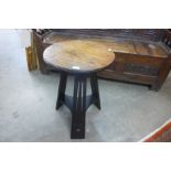 An Arts and Crafts oak circular occasional table