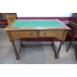 An Edward VII oak two drawer writing table