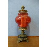 A gilt metal and red glass table lamp