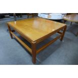 A teak square coffee table
