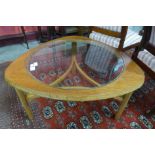 A Nathan teak and glass topped triangular coffee table