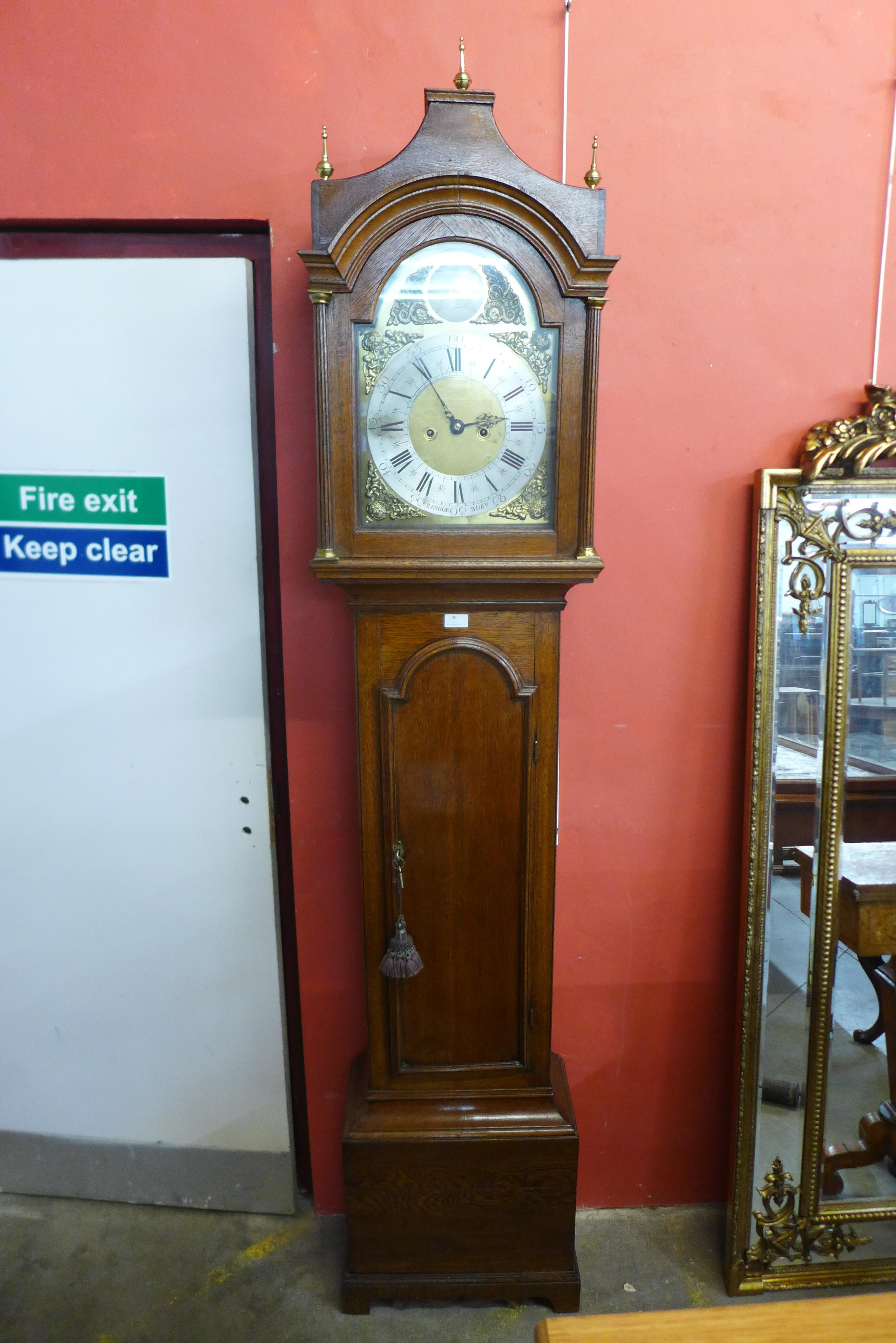 A George III Lancashire oak 8 day longcase clock, the 12 inch arched brass dial signed Raynor, Bury