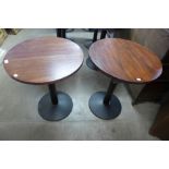 A pair of circular oak and steel based bistro tables