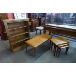 A teak coffee table, a nest of tables and an open bookcase