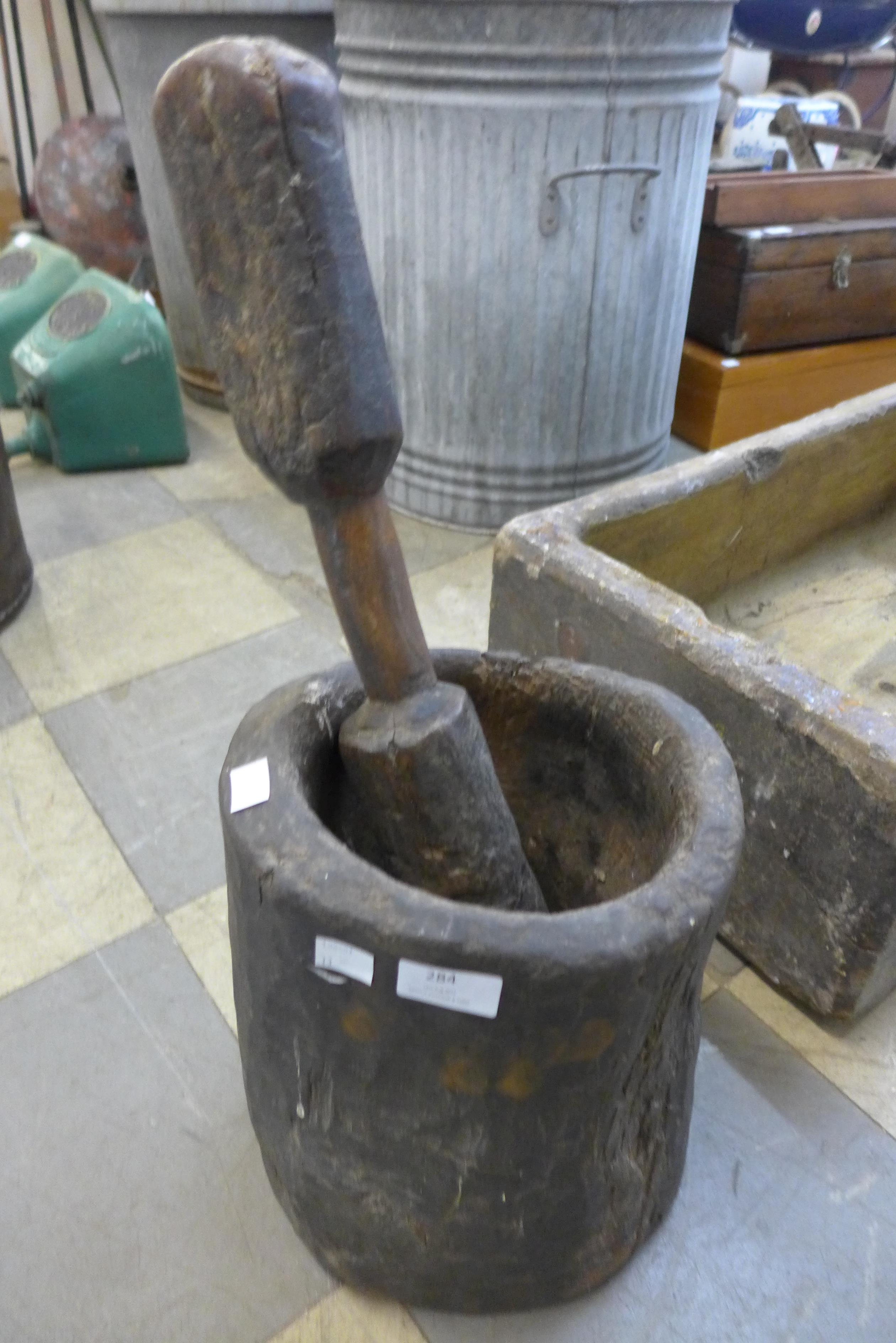 A large 19th Century carved hardwood pestle and mortar