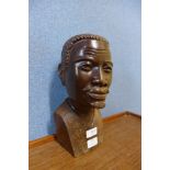 An African carved hardwood bust of a man, marked Masimba K. Musoro