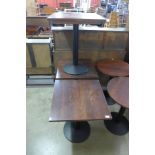 A set of three oak and steel based bistro tables