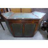 A mahogany and green leather panelled bar