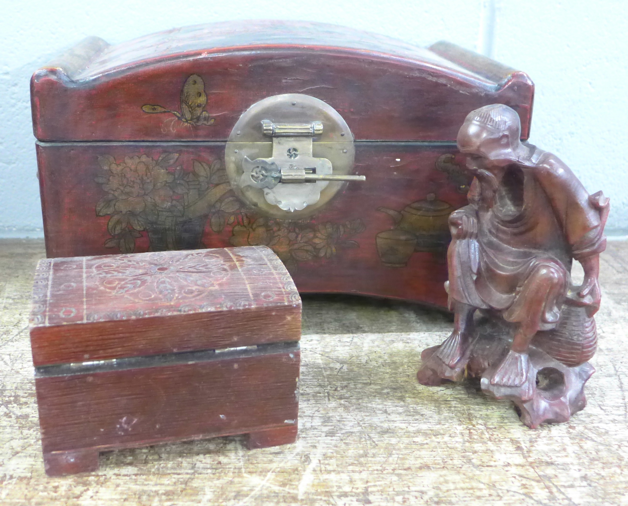 A Chinese casket, a wooden box and a carved figure of an elder