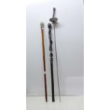 Two walking canes and a fencing sword