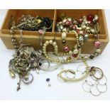 A wooden box containing costume jewellery