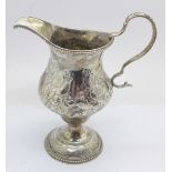 A Georgian silver cream jug, worn London hallmark, 98g, a/f, dented and possibly repaired