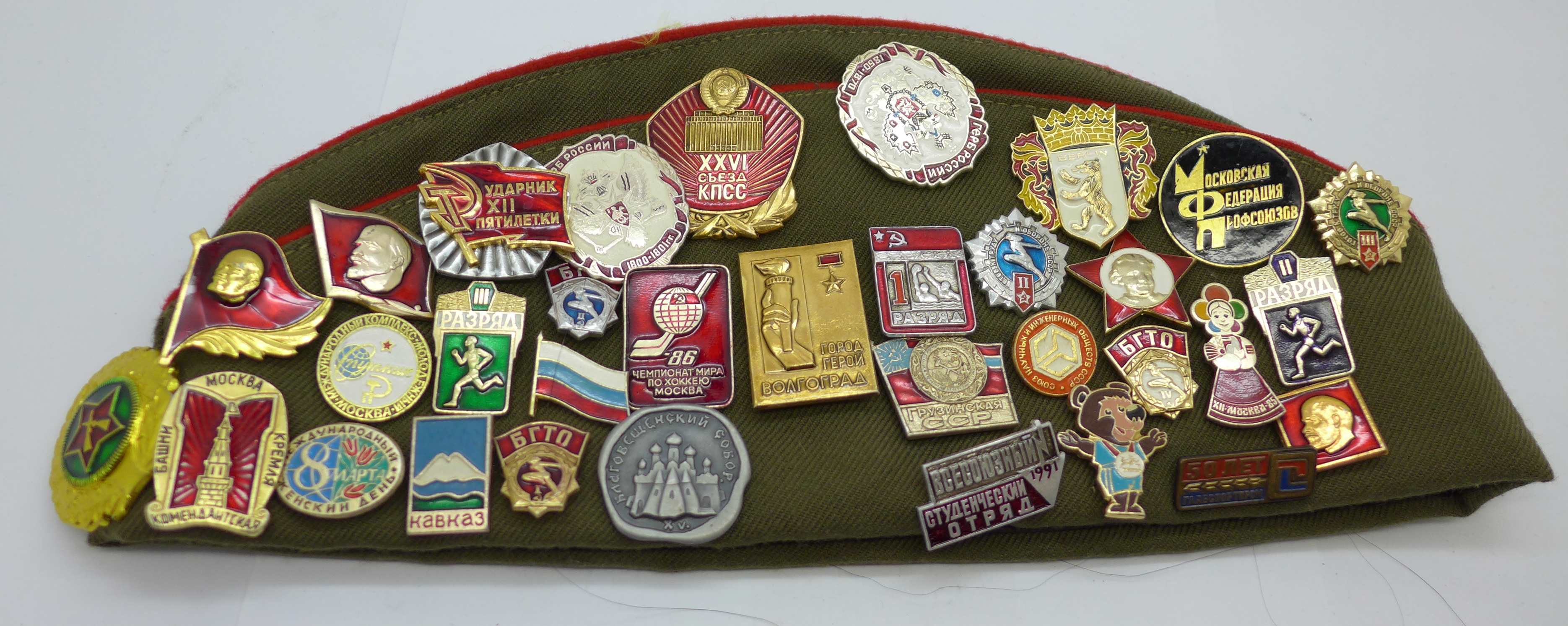 A Soviet cap with a collection of badges