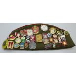 A Soviet cap with a collection of badges