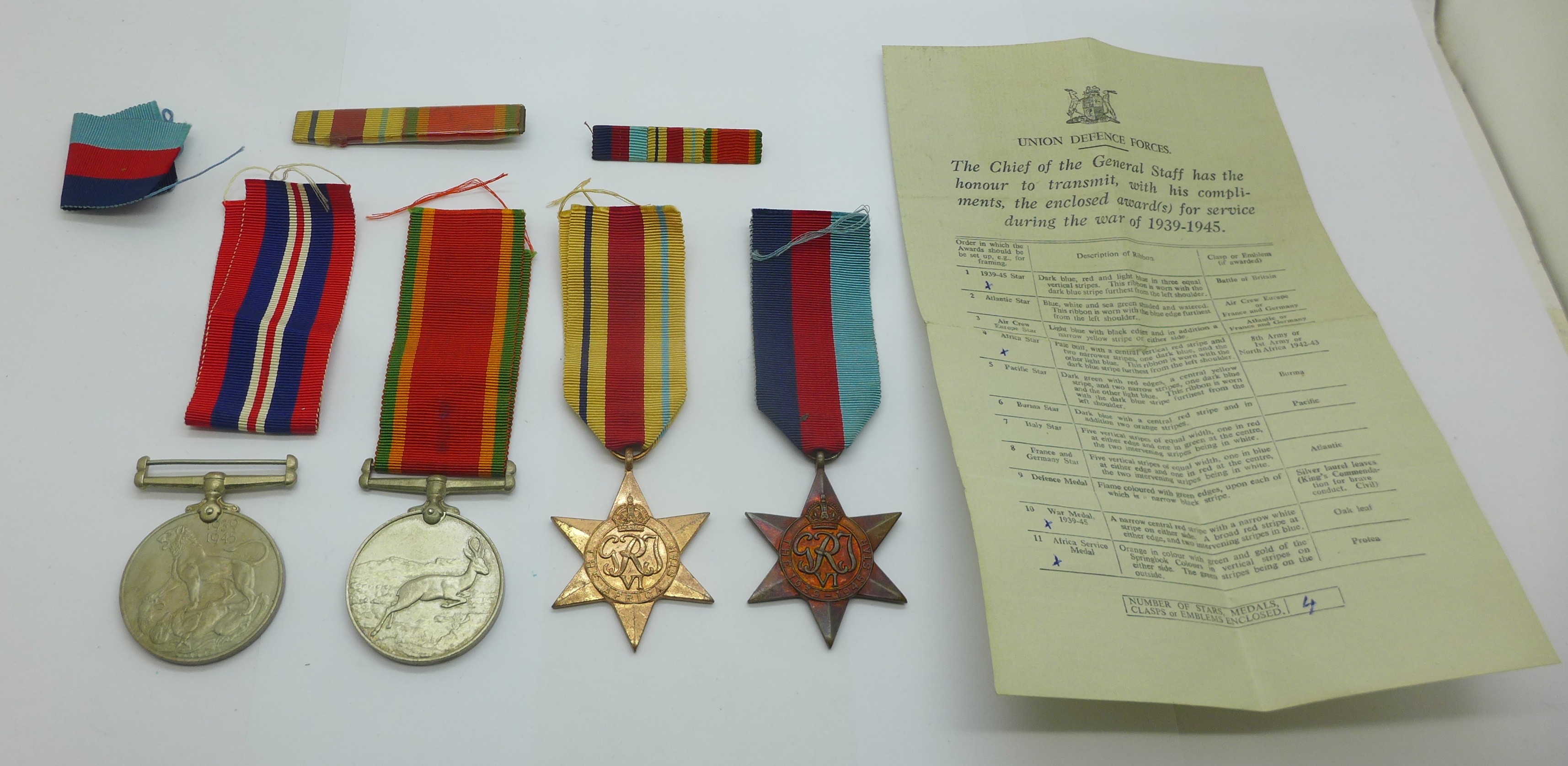 Four WWII medals including Africa Service Medal to 113405 G. J. Simpson with compliment slip