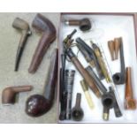 A collection of pipe cases, stems, bowls and a glass pipe, etc.
