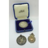 Two silver fob medals, one with crossed rifles and one cat show medallion, and a boxed silver