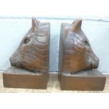 A pair of carved wooden boar's head bookends