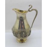 An Indian white metal cream jug with cobra handle, (tests as silver), a/f, bottom of handle requires