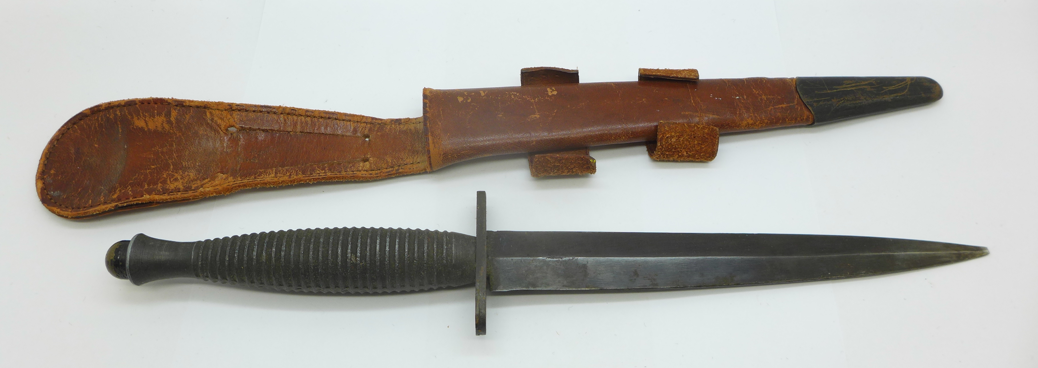 A commando knife with scabbard, tip of blade a/f