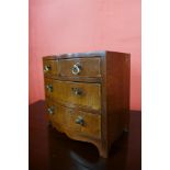 A Victorian apprentices miniature inlaid mahogany bow front chest of drawers