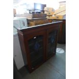 An Edward VII oak and stained glass two door bookcase top