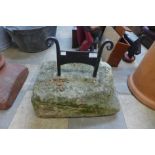 A boot scraper on stone base