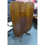 A George IV mahogany rectangular tilt top dining table