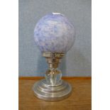 A blue glass globular table lamp on chrome base