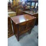 A carved oak two door cupboard