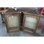 A pair of 19th Century carved walnut wall hanging cabinets