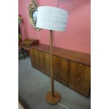 A teak standard lamp