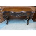 A George IV Irish carved mahogany serpentine console table