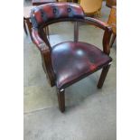 A mahogany and red leather desk chair