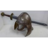 A replica metal Viking helmet and a modern replica re-enactment sword in plastic