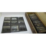 A wooden box with approximately one hundred glass slides, subjects include views of the UK, Italy