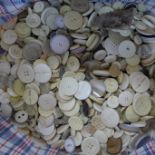 A large collection of cream buttons