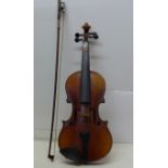 A violin, with paper label 'Copy of Antonius Stradivarius, Cremona, Made In Germany', length of back