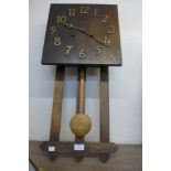 An Arts and Crafts oak wall clock