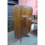 A George IV mahogany rectangular tilt top dining table