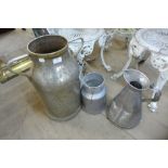 A stainless steel milk churn and two others