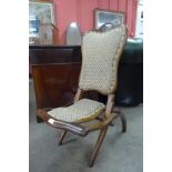 A Victorian carved walnut folding chair