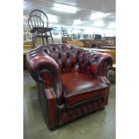 A red leather Chesterfield club armchair