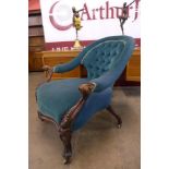 A Victorian carved rosewood and fabric upholstered open armchair