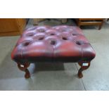 An oxblood leather footstool