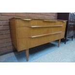 A teak chest of drawers