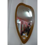 A teak framed asymetrical mirror